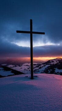 Vertical video of Colorful sunrise over winter countryside nature with religious christian steel cross in top of snowy hill with fast clouds sky Time lapse