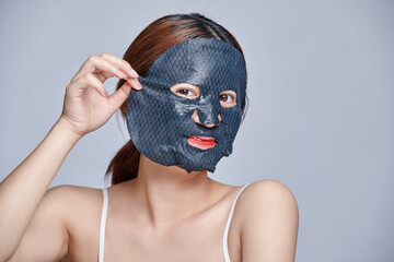 Asian woman with facial mask, beauty skin treatment,  procedure. Asia girl with black facial mask isolated. Beauty spa and cosmetology. skin care concept.