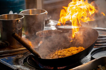 Pad Thai favorite and famous Asian Thai street fast food in hot pan, Pad Thai is stir fried rice noodle dish commonly served as a street food and at casual local eateries in Thailand