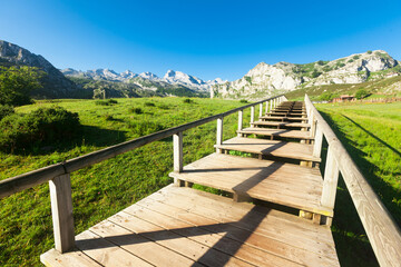 Fototapeta na wymiar view with a wooden walkway to national park peaks of europe