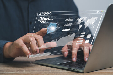 business documents on office table with laptop computer and trade graph financial with social network diagram and man working in the background.