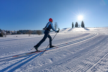 nice, active woman cross country skiing in the Bregenz Forest Mountains near Sulzberg, Vorarlberg,...