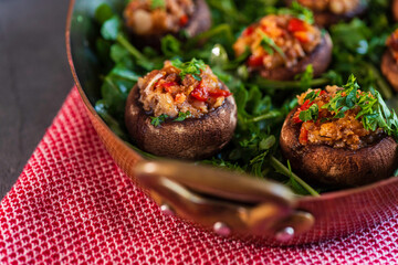 Mushroom caps stuffed with scallions, red bell peppers, and cheese; served on a bed of arugula.
1d