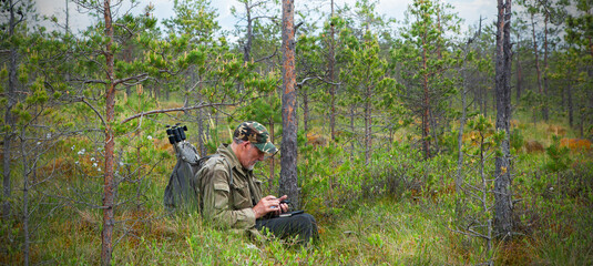 An adult man with a beard, ornithologist, birdwatcher, biologist.