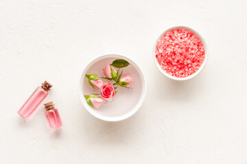 Pink roses cosmetic products set with flowers essential oil. Beauty care concept.
