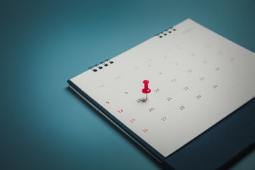 Embroidered red pins on a calendar event Planner calendar,clock to set timetable organize schedule,planning for business meeting or travel planning concept.