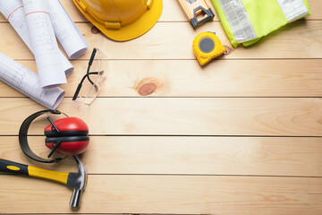 Work safety. Standard Construction site protective equipment on  top view wooden background, flat lay, copy space,safety first concepts.