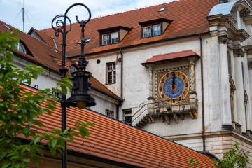 Old clock on the wall made of mosaic in the center of Poznan.