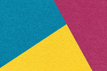 Fototapeta premium Texture of craft yellow, purple and blue shade color paper background, macro. Vintage abstract turquoise cardboard