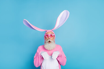 Photo of excited fooling man pensioner dressed pink rabbit nightwear heart eyewear rising arms...