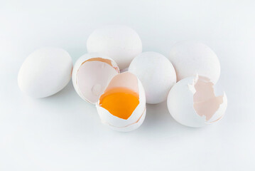 On a white background, eggs, shell and broken egg.