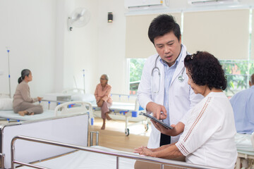 Doctor in charge of an elderly nursing home center is examining an elderly person in health care center.