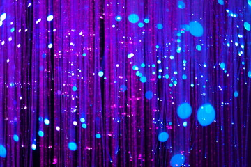 Striped wallpaper of purple lights pouring vertically