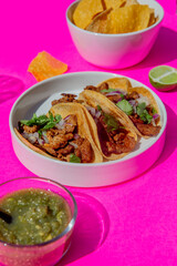 Esthetic flash food photography of Mexican taco table setting with shadows on bright color background
