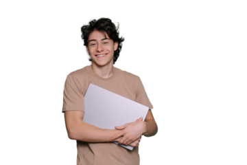 Handsome caucasian cheerful student guy carrying laptop looks at camera broad smiles stands against transparent background with copy space for ad. Mockup, youth, students life. Boy with new computer