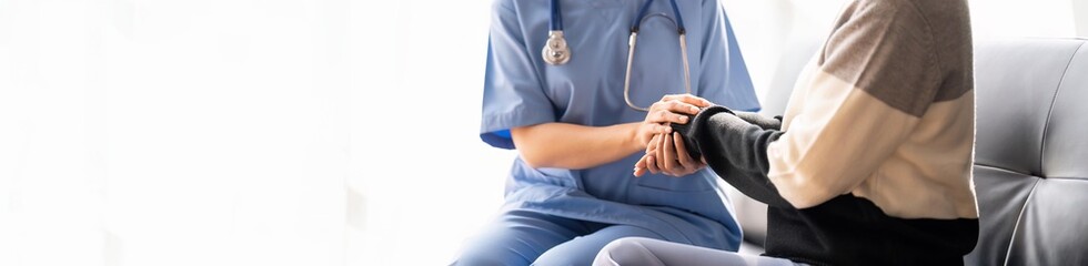 Home caregiver and senior woman holding hands. Professional Elderly Care. Professional care for...