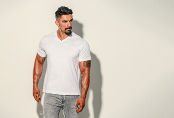 Handsome Athletic man in white t-shirt and jeans
