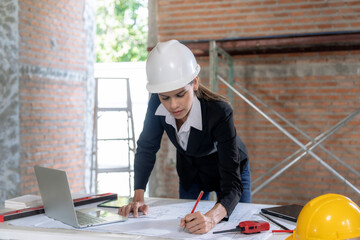 Caucasian female architect working on construction site.