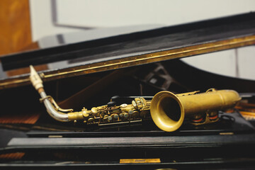 View of a saxophone player in headphones during rehearsal, recording sound for new album song at...