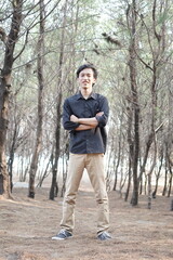 Smiling Man with Folded Hands among Dry Trees