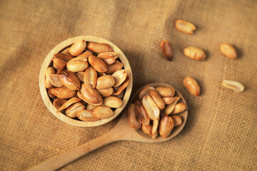 Yellow roasted groundnut on sack for healthy food eating or being in cooking ingredient. selective focus.