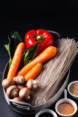 Food preparation concept Ingredients of Japchae korean potato noodles on black background
