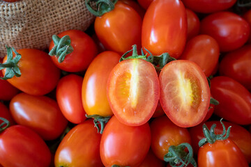 Fresh tomatoes with cut in half and dripping juice 