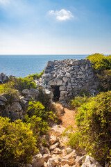 Gagliano del Capo. The beautiful panorama on the blue sea, from the rocky cliff of Salento. An old stone trullo. The nature trail that leads from the Ciolo bridge to the spectacular Cipolliane caves.
