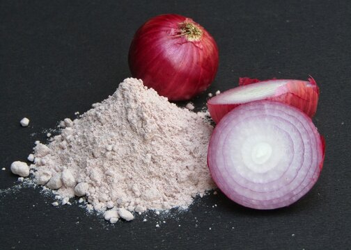 Red Onion powder with onions on black background 