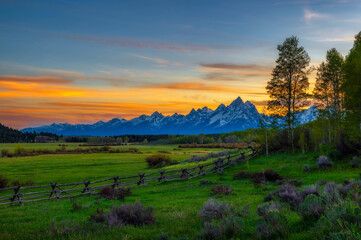 Naklejka na ściany i meble Colorful sunset above the Grand Teton mountains in Wyoming