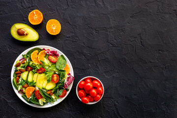 Healthy vegetarian bowl - green salad with avocado and tomatoes