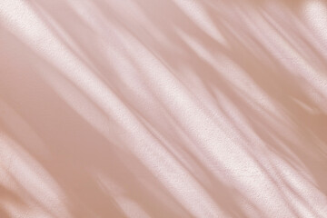 Abstract light shadow of beige, pink bokeh background. Natural diagonal leaves tree branch pastel pink shadows and sunlight dappled on white wall texture, shadow overlay effect