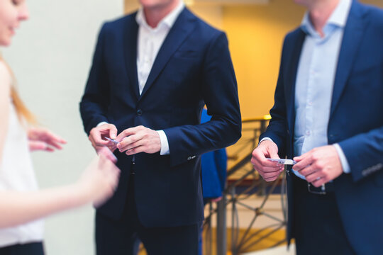 Process of checking in on a conference congress forum event, registration desk table, visitors and attendees receiving a name badge and entrance wristband bracelet and register electronic ticket