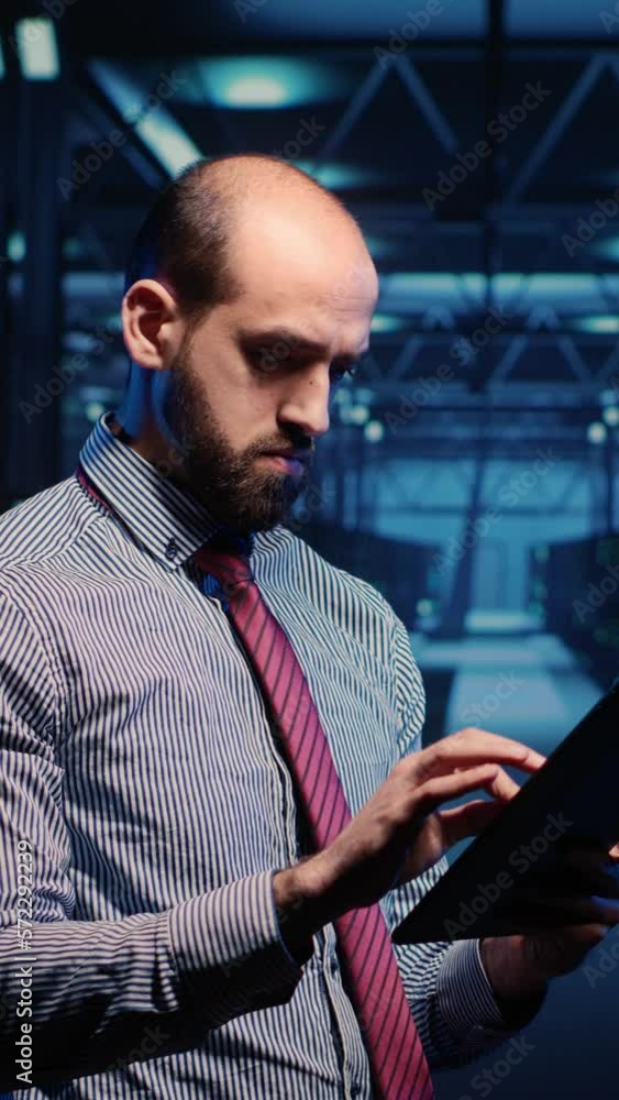 Aufkleber vertical video: system administrator activating hardware in data center with tablet, analyzing moder