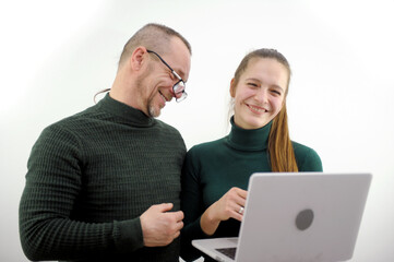 Fototapeta premium adult man flirting with girl smiling flirting prank joke embarrassment man trying to like man with glasses on nose looking at a monitor on a computer an interesting dating device on airplane