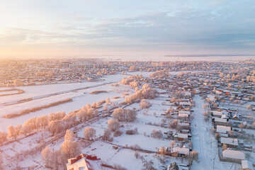 Small town covered with snow and frost in winter at dawn