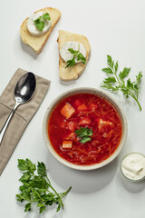 Ukrainian borscht in a plate with lard on bread on the background top view