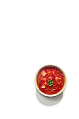 Ukrainian borscht in a plate on a white background, top view