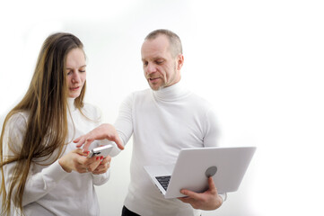 boss nervously takes the phone from employee of subordinate intern in hands of laptop on white...