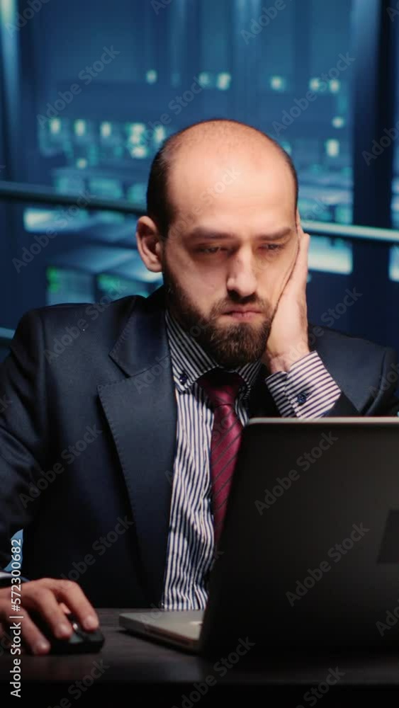 Poster vertical video: information security officer finishing digitalization work in professional data cent
