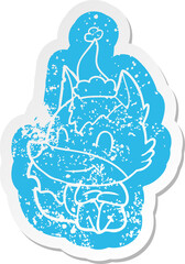 friendly cartoon distressed sticker of a wolf wearing santa hat