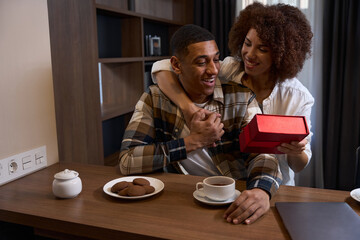 Charming multiracial wife wishes her happy husband a happy birthday