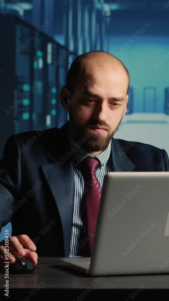 Poster vertical video: system administrator working in data center render farm, creating cloud computing se