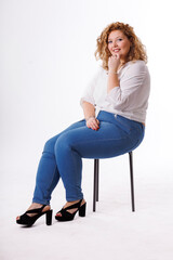 Fototapeta premium Plus size fashion model, fat woman in denim clothes and white shirt on white background, overweight female body