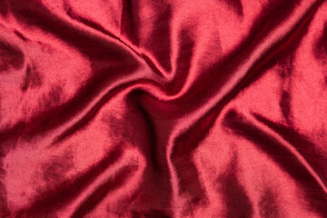 Smooth elegant burgundy silk or satin luxury fabric texture. Top view