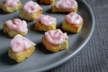 Small crostini with tarama or taramasalata canape isolated on the gray plate close-up
