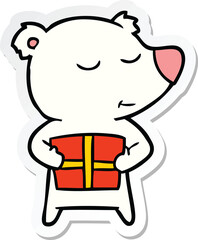 sticker of a happy cartoon polar bear with present