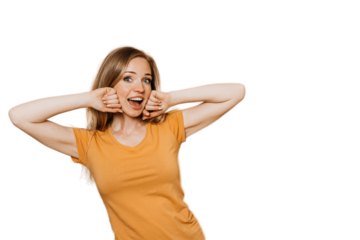 Cheerful redhead young woman smiles with her mouth wide open, touches her face, being in  great mood, had good sleep, poses on transparent background with a copy of the space. Concept of active people