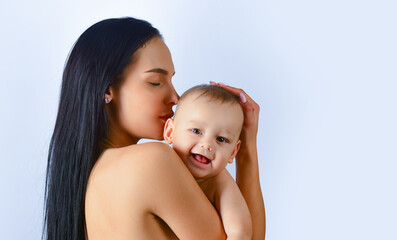 Mother hug. Closeup studio portrait of mother and baby child isolated on whtite. Mother hugging and embracing baby son. Mothers day, love family. Mother and baby child with tenderness.