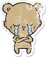 distressed sticker of a crying cartoon bear with folded arms